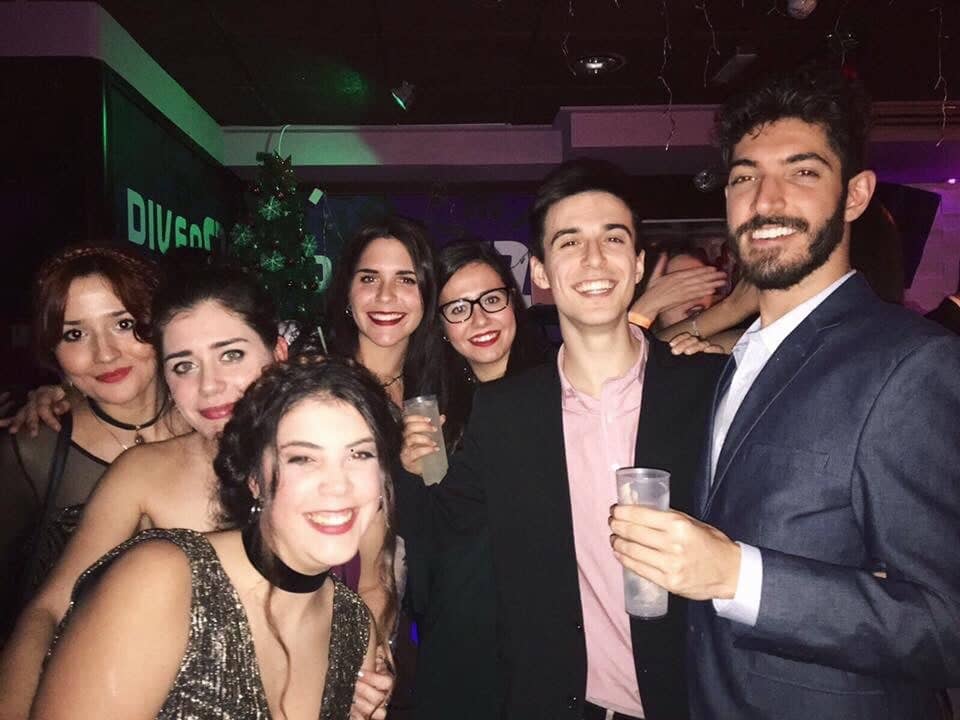 Rocky smiling with a group of friends at an event