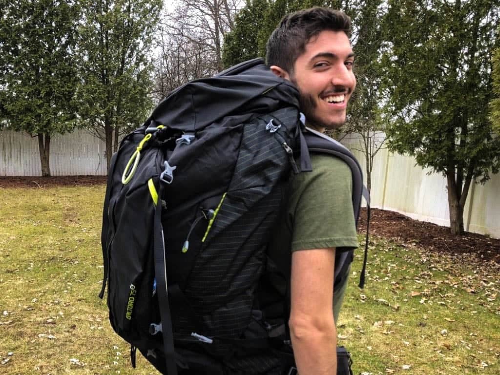 Rocky looking back with a large travel backpack