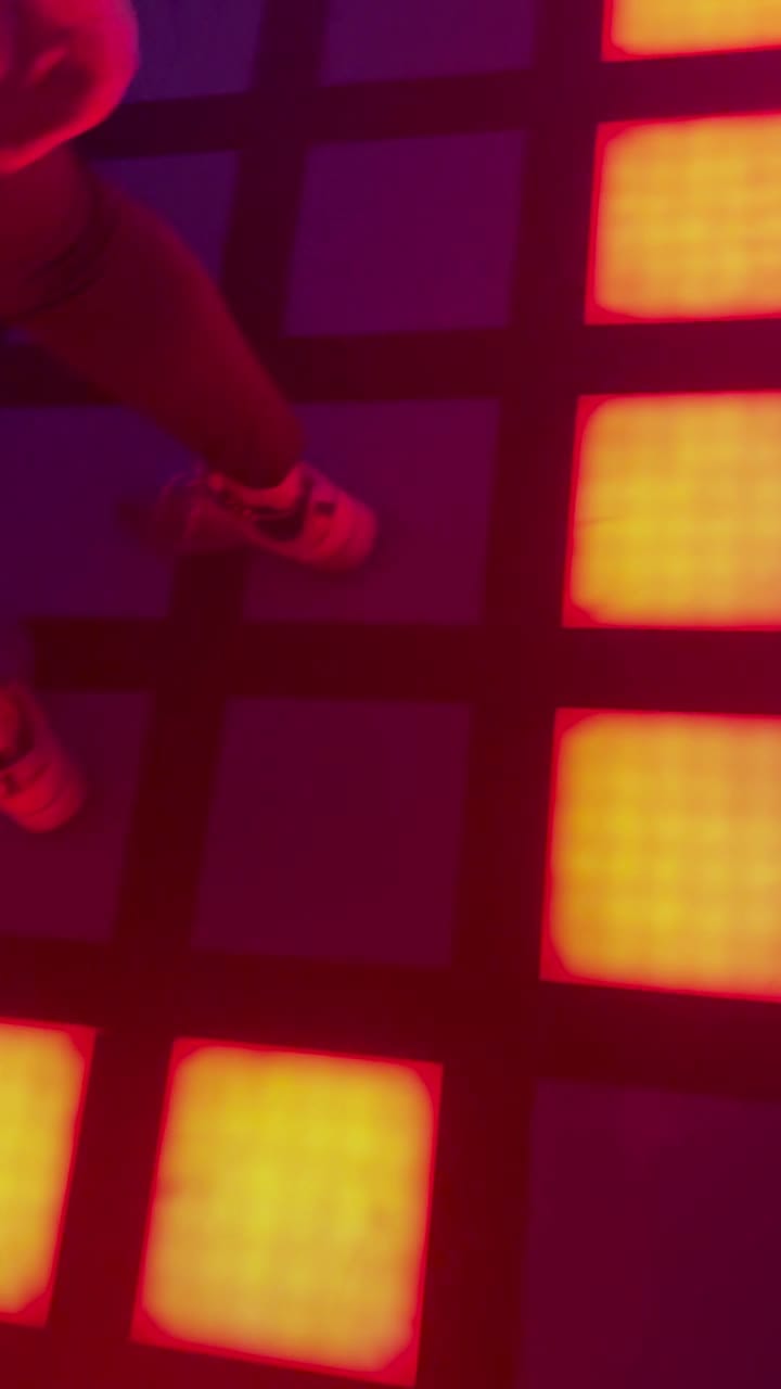 A grid of glowing coloured floor tiles at ACTIVATE
