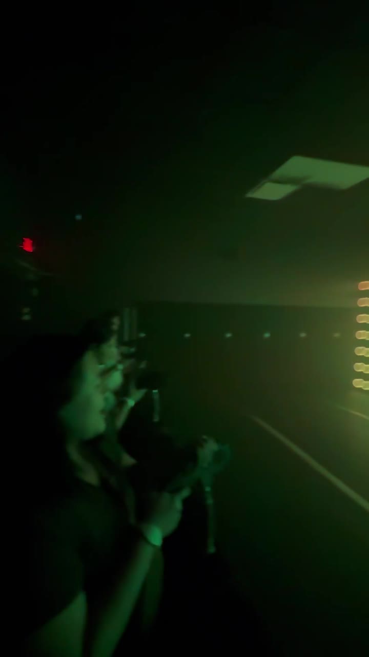 A dark room criss-crossed with green laser beams at ACTIVATE