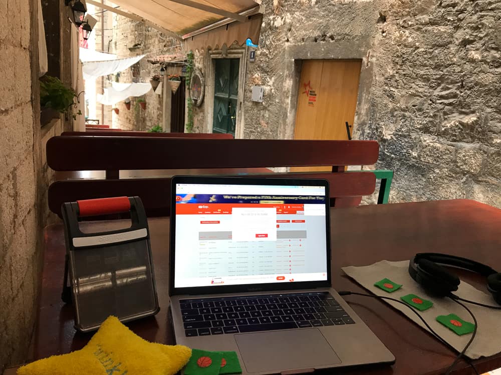 A laptop set up to teach on an outdoor table in a Šibenik alleyway