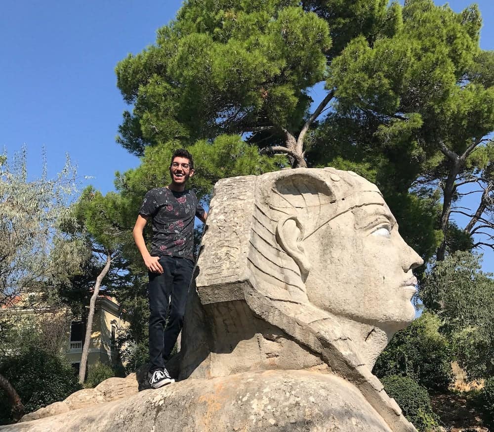 The Zadar sphinx in its garden, a person standing beside it