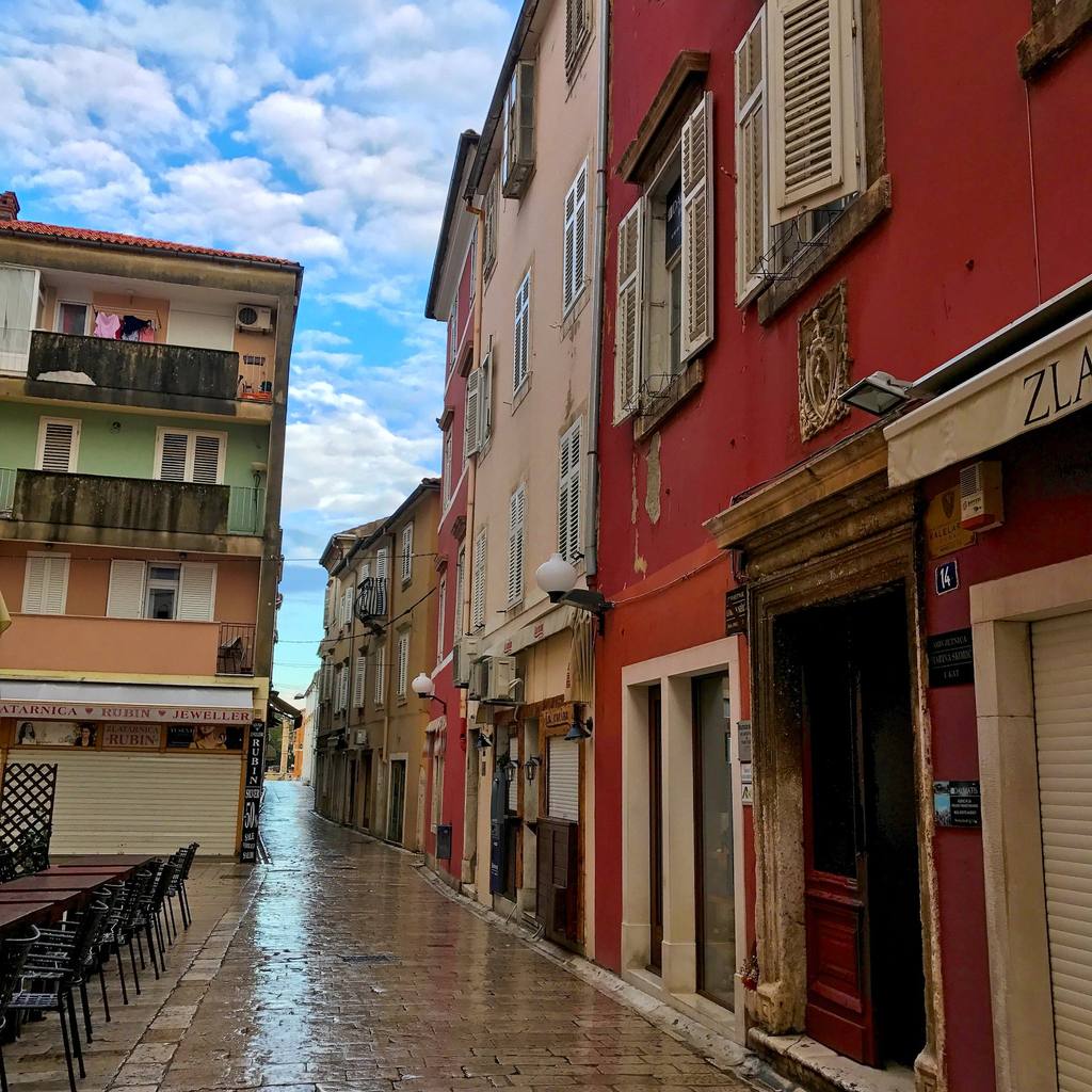 A narrow Zadar street lined with painted buildings
