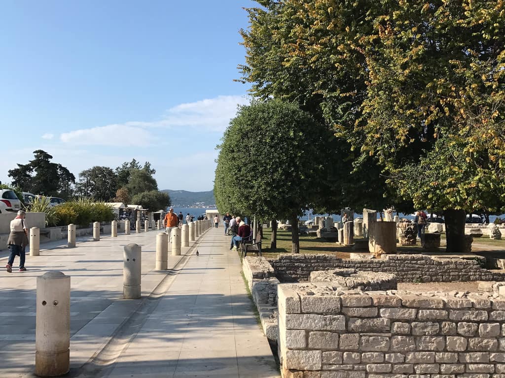 Roman stonework laid out on the grass in Zadar