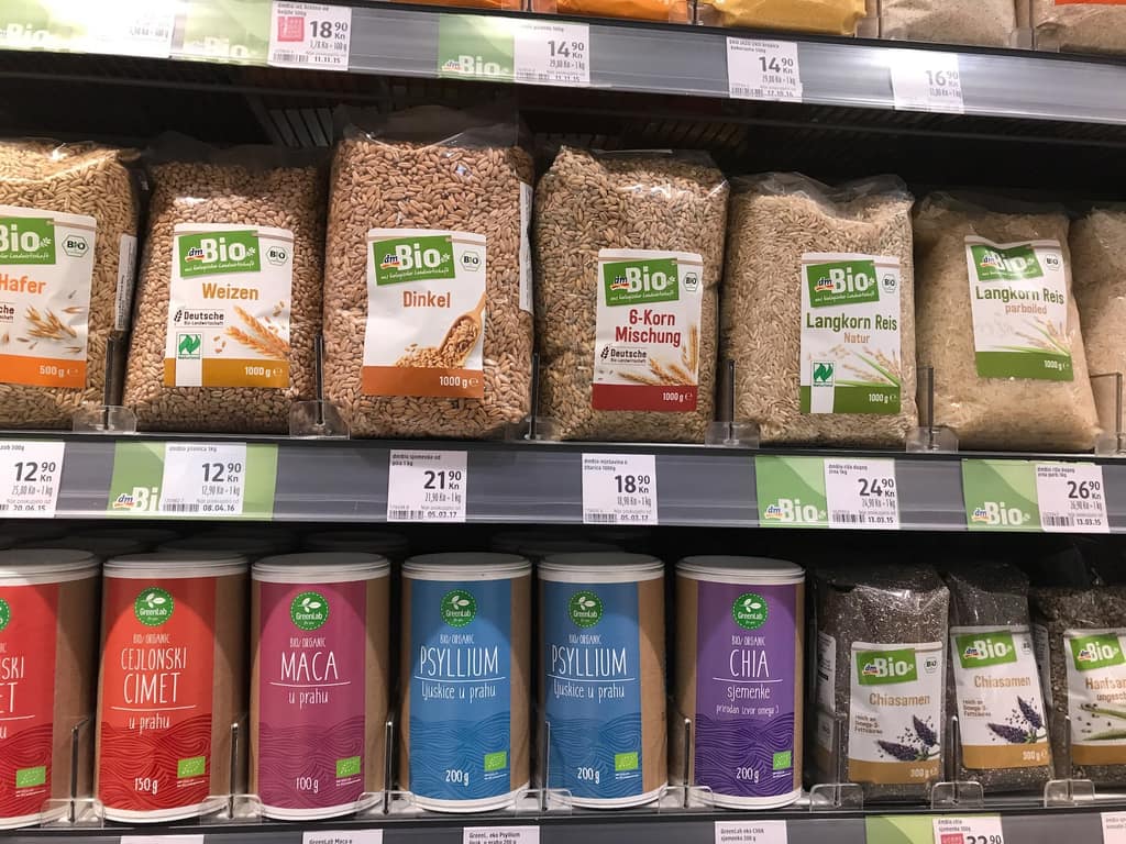 A Croatian supermarket shelf stacked with bags of grains
