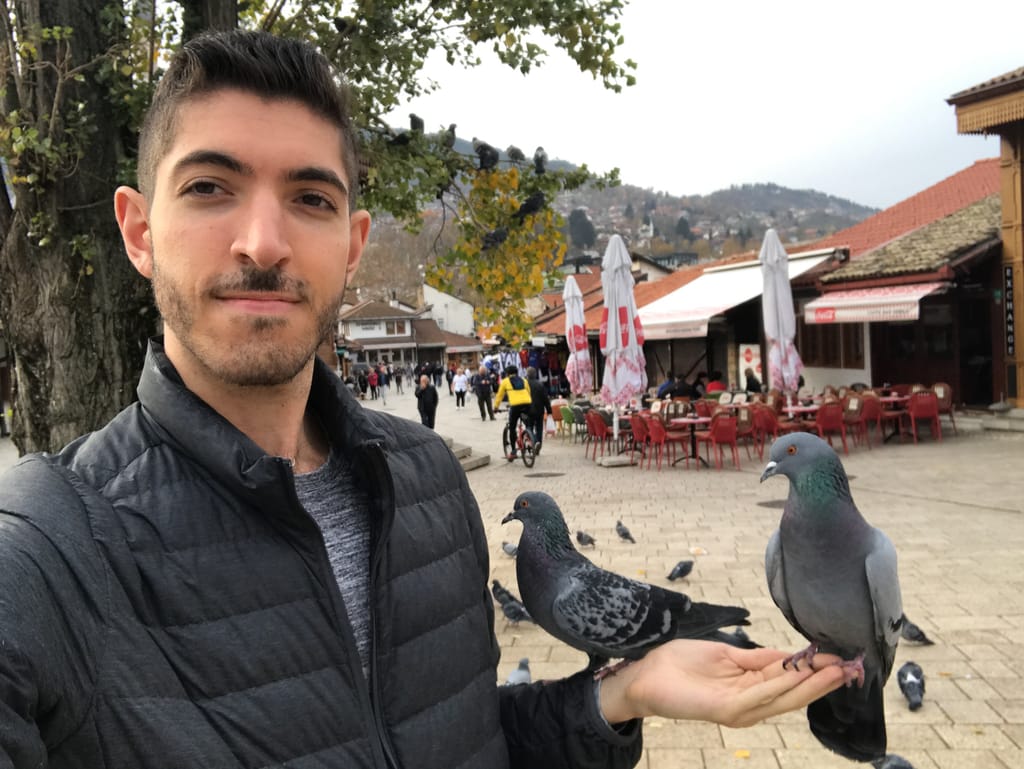 Rocky holding pigeons in Sarajevo