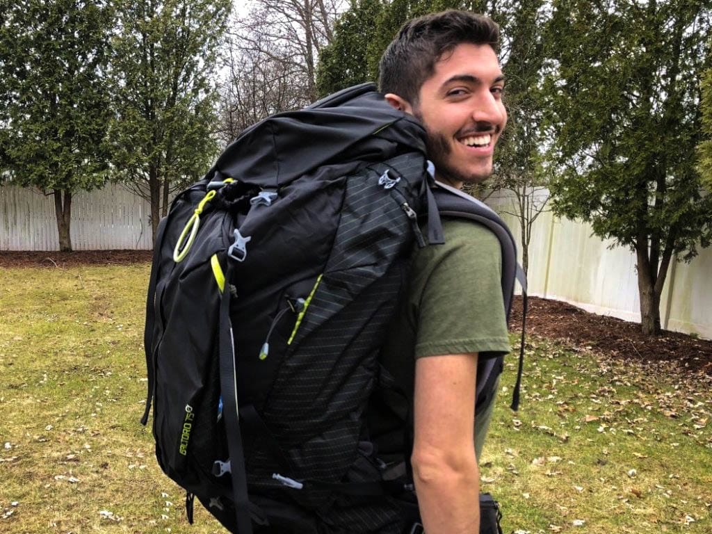 Rocky looking back over his shoulder wearing a large travel backpack