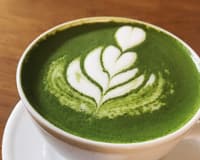 A matcha latte with leaf art in a Warsaw cafe