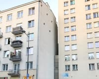 The narrow Keret House wedged between two much larger Warsaw buildings