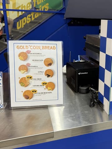 The gold coin bread counter at Speedy Korea Grill, with a menu of fillings and a blue-and-white checkerboard divider