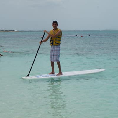 Rocky paddleboarding on clear shallow water in Turks and Caicos