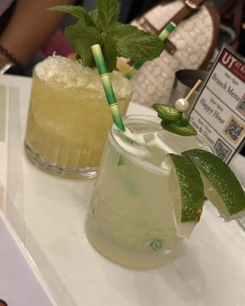 Two soju cocktails at UT47: a Jalapeno Wasabi with lime wedges and jalapeno slices, and a SpongeBob's Crib topped with mint