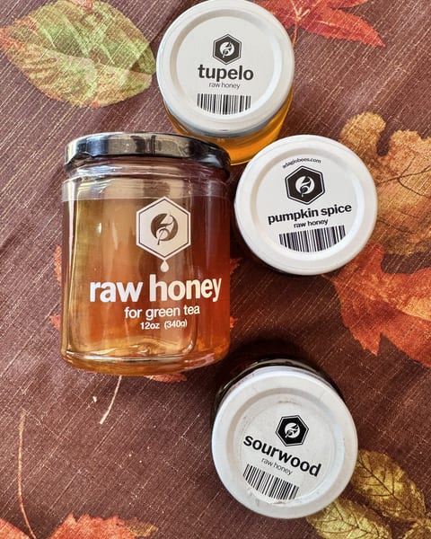 Adagio raw honey for green tea, 12 oz, surrounded by the small sampler jars