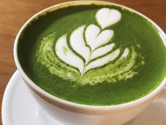 A matcha latte with leaf art in a Warsaw cafe