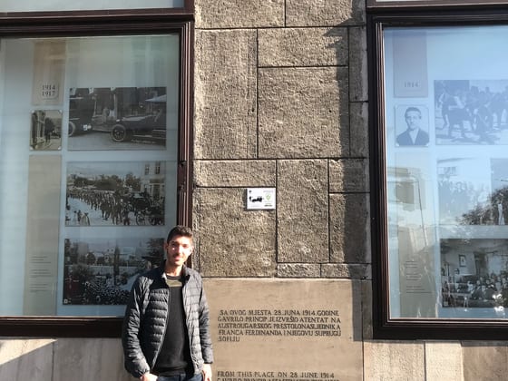 Rocky standing at the corner where Archduke Franz Ferdinand was assassinated