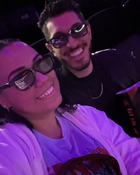 Rocky and Carolyn wearing 3D glasses in their seats at the 4DX showing, Carolyn in her Stitch sweatshirt