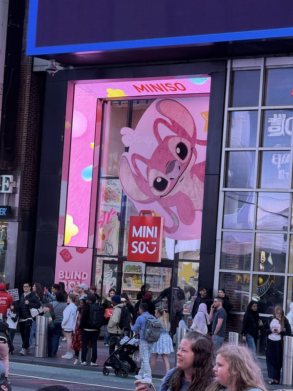 The Miniso store in Times Square with a giant pink Angel from Lilo and Stitch filling its window display