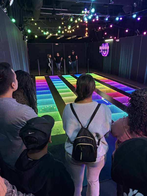 The Memory Steps room: a grid of glowing LED floor panels with players waiting at the edge