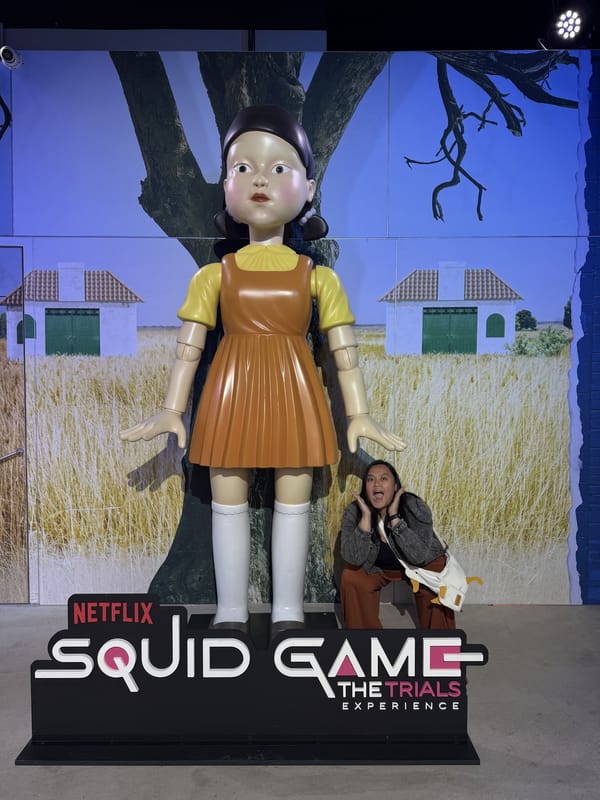 Tracy posing dramatically at the feet of the Young-hee standee