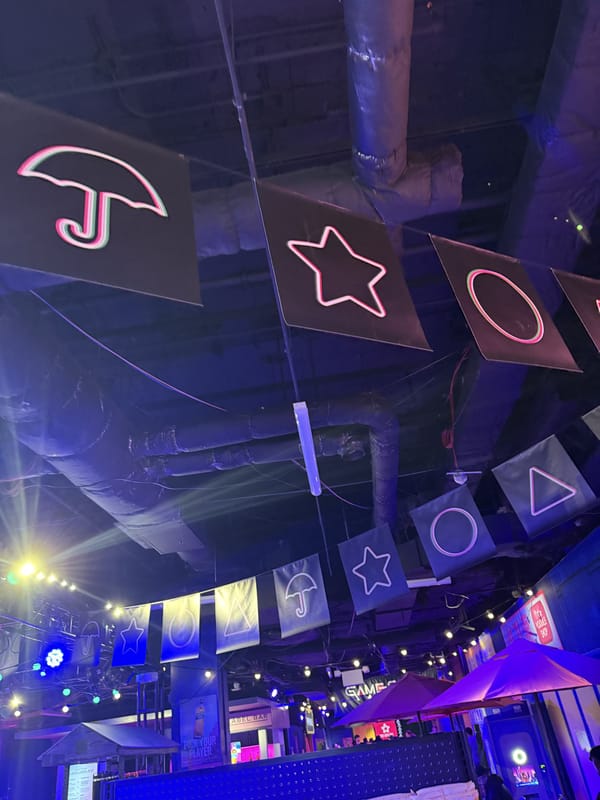 Neon circle, triangle and square shapes hanging from the ceiling