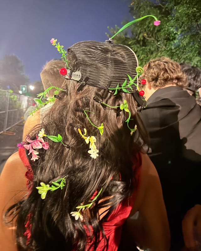 The back of Tiffany's head, her long dark hair and cap covered in tiny flower and sprout clips
