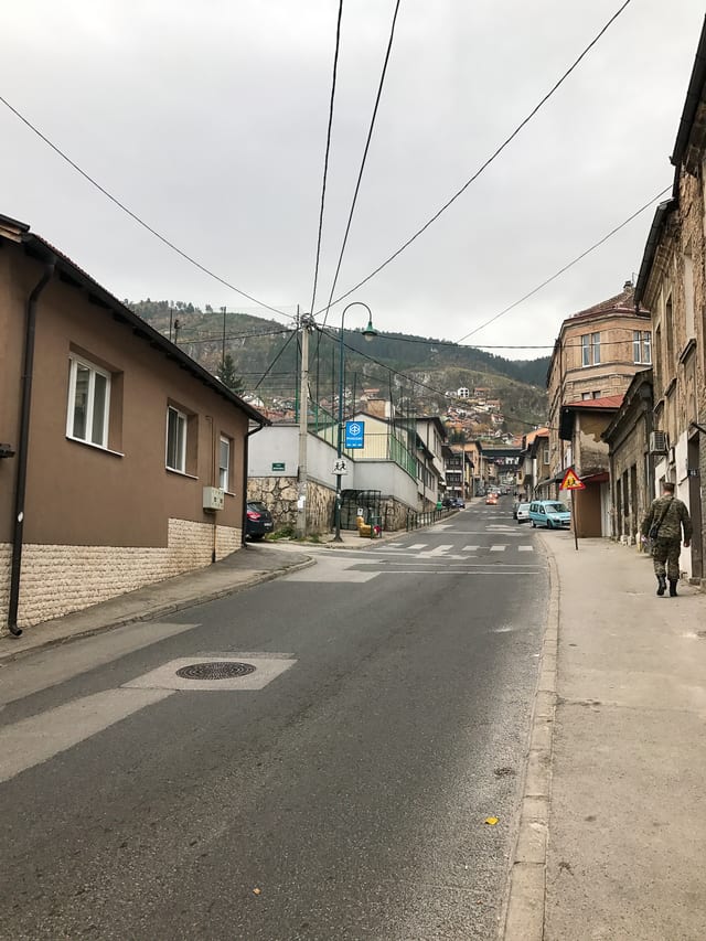 Rocky leaving his apartment in Sarajevo to walk outside