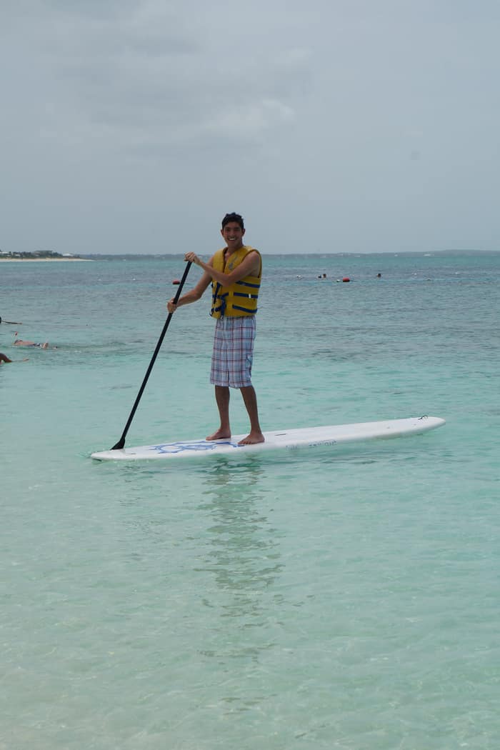 Rocky paddleboarding on clear shallow water in Turks and Caicos