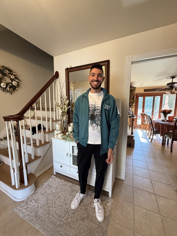 Rocky at home in the teal 287 tracksuit before leaving for the city