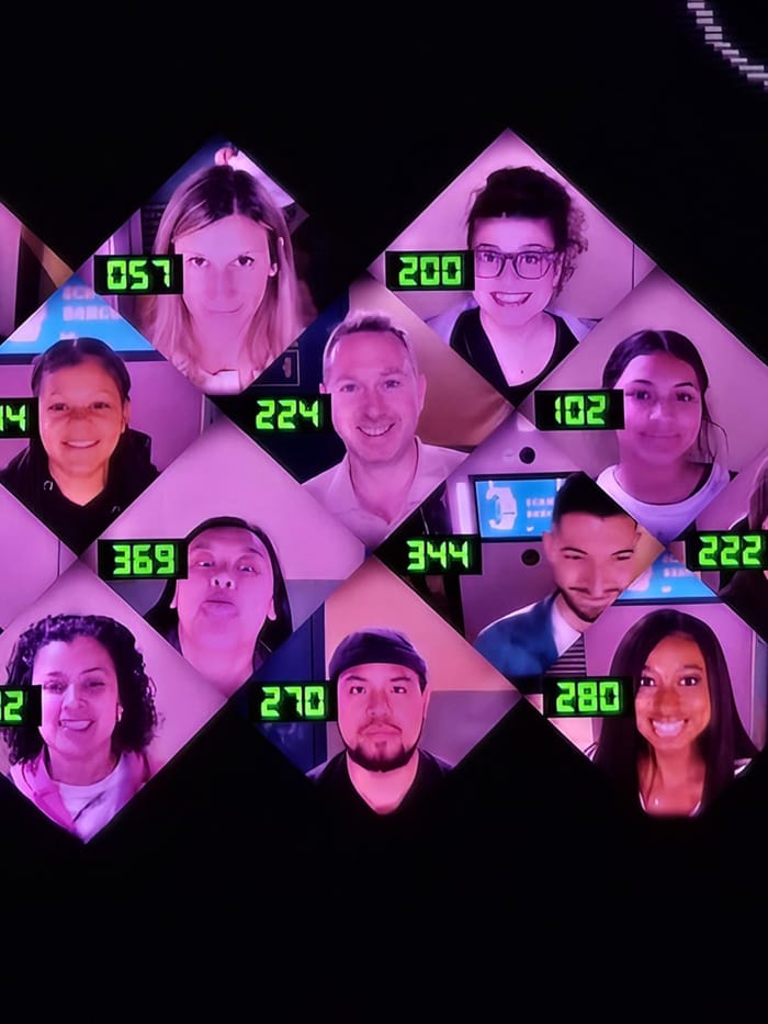 The player wall of registered faces and numbers on the screens