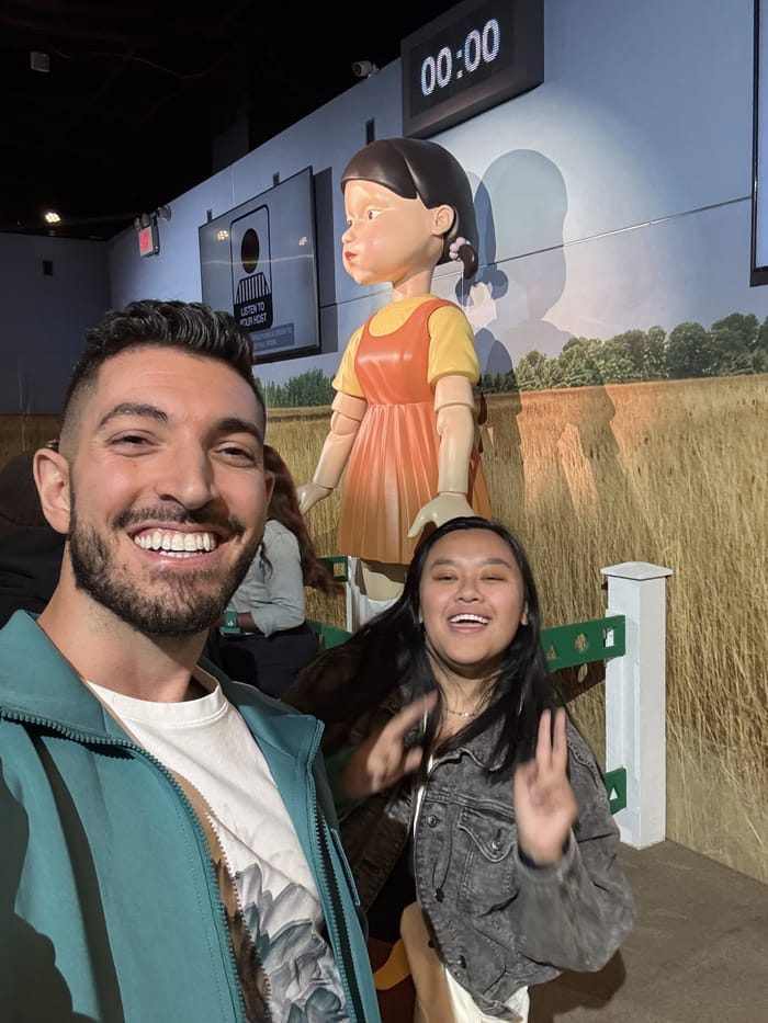 Rocky and Tracy in front of the giant Young-hee doll with the clock at 00:00