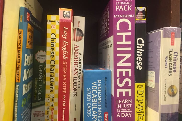 Four Chinese phrasebooks laid out on a table