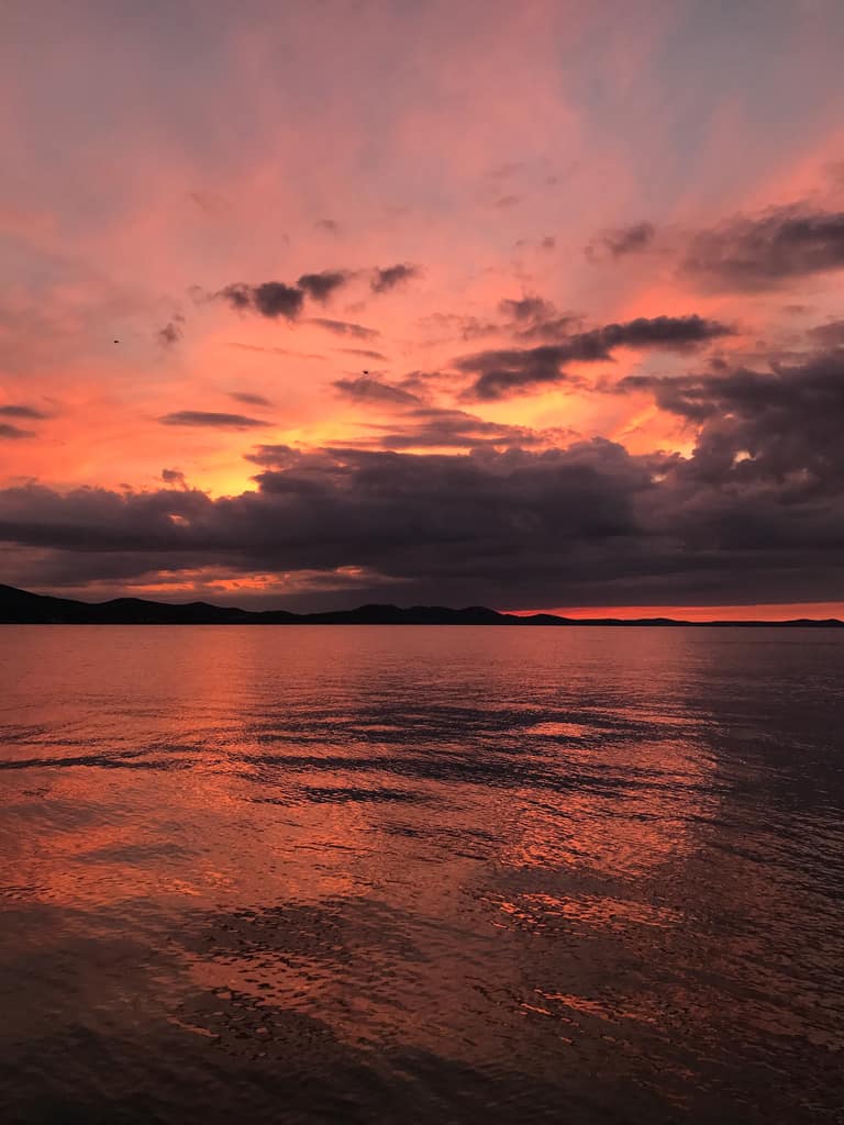 A deep red sunset over the water at Zadar