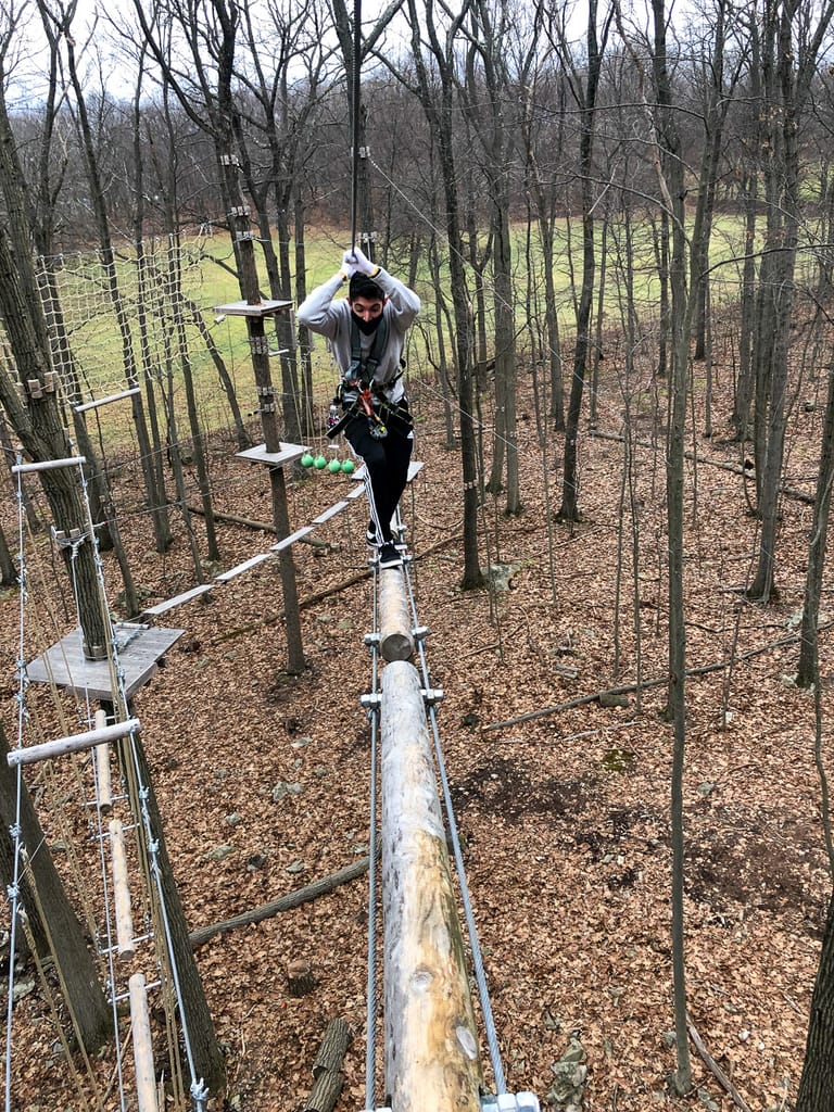 Walking on a beam at FLG X New Jersey Adventure and Zip Line Course