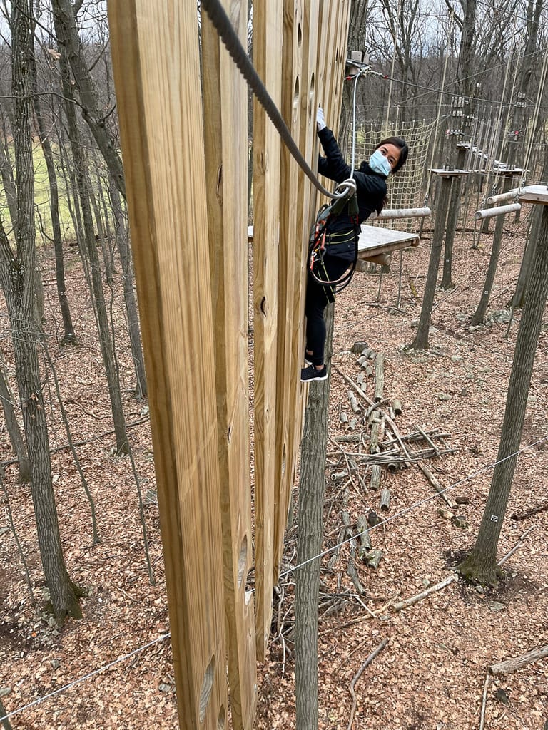 Scaling a wooden wall at FLG X New Jersey Adventure and Zip Line Course