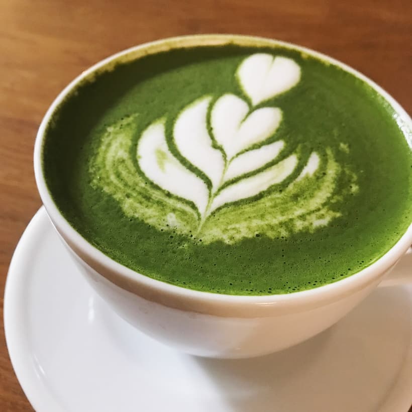 A matcha latte with leaf art in a Warsaw cafe