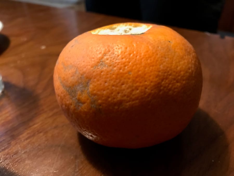 Tasting an orange picked from a Valencia street tree