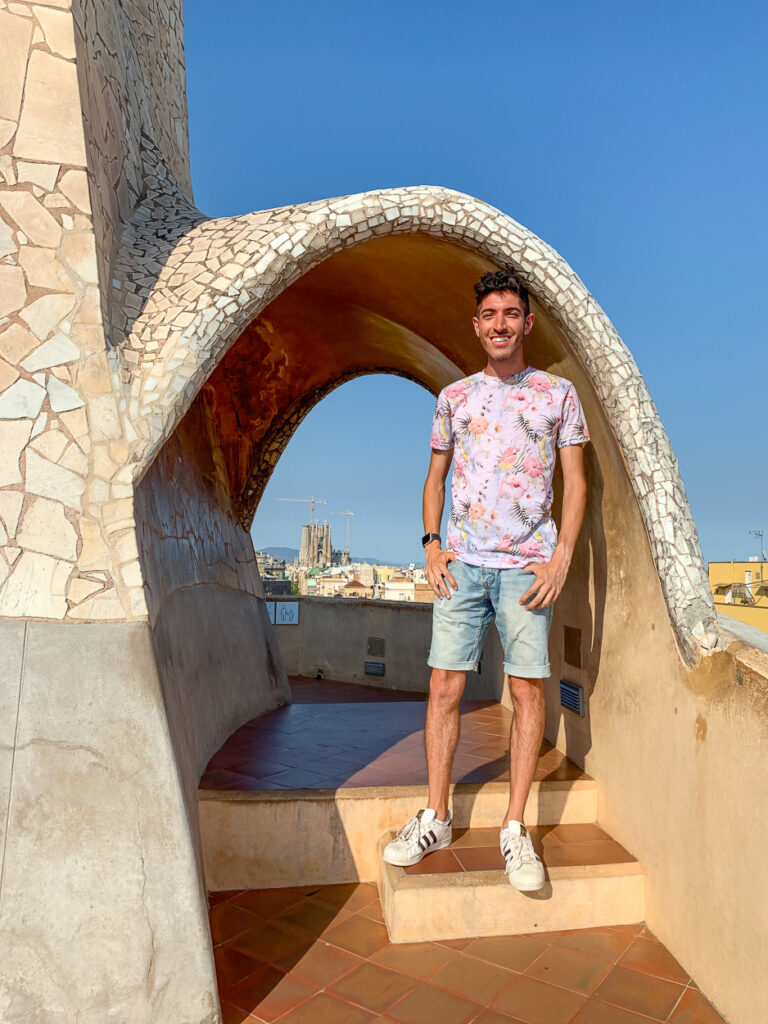 Rocky poses on the roof of Casa Mila with La Sagrada Familia in the background