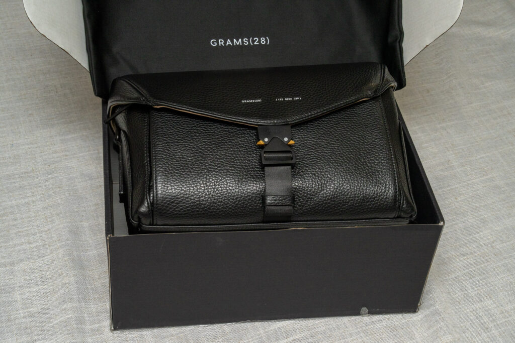 The 172 Camera Sling by Grams28 in its shipping box